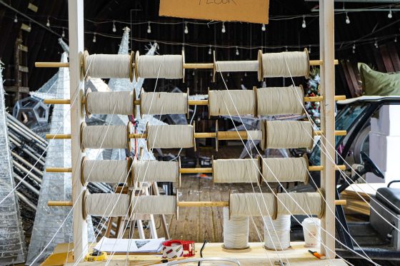 Eighteen spools of white string.