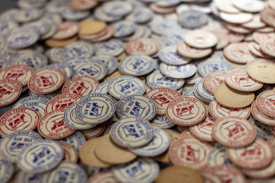 Hundreds of old milk bottle caps, in red and blue in a pile.