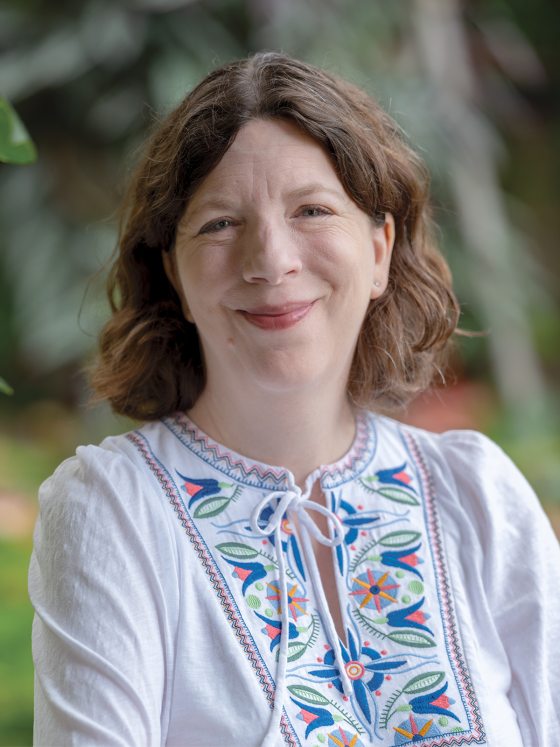 headshot of woman wearing a white blouse smiling