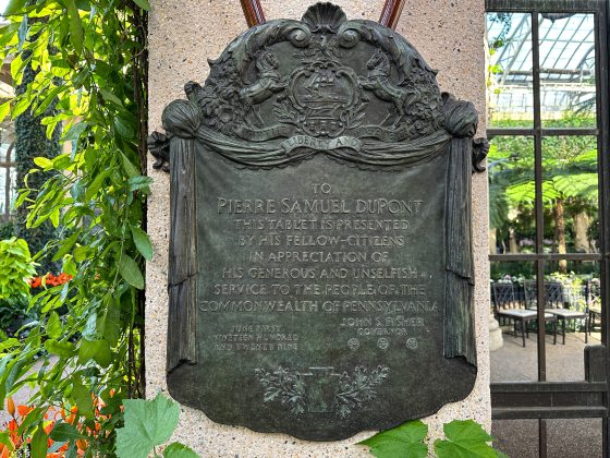 A bronze plaque with text in the Longwood Conservatory.