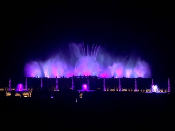 The Main Fountain Garden at Longwood with its fountains at night lit up in all purple.