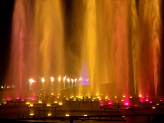 The Main Fountain Garden lit up with yellow and red lights in each fountain.