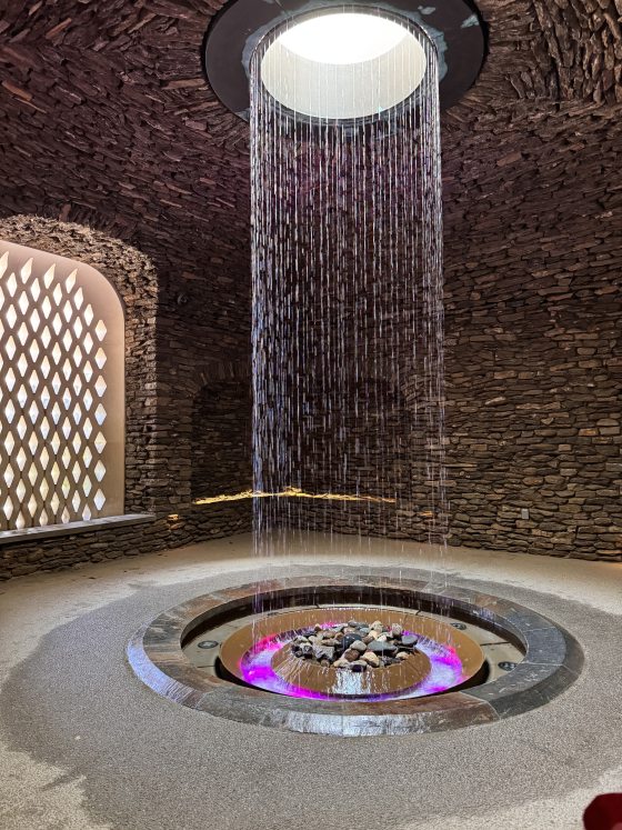 A stone grotto, with a circle fountain of water, raining down from the ceiling.