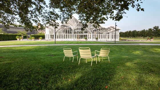 Three white chairs overlooking the new conservatory at Longwood Gardens.