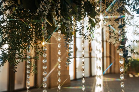Long crystal like features hanging from greenery. 