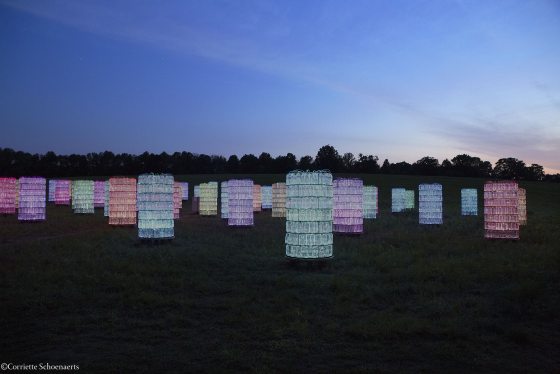 lit up towers in a range of colors in a field