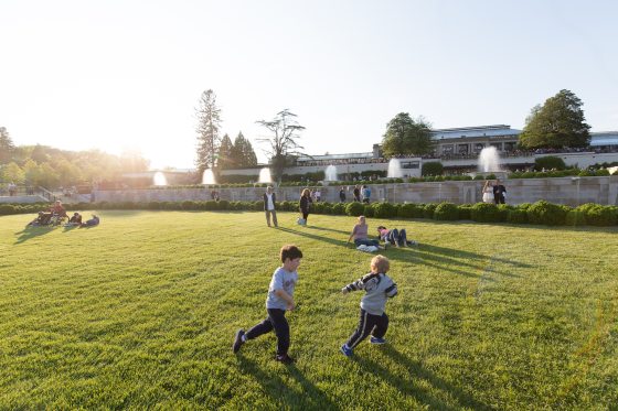 children running around the lawn of the renovated Main Fountain Garden on a sunny day