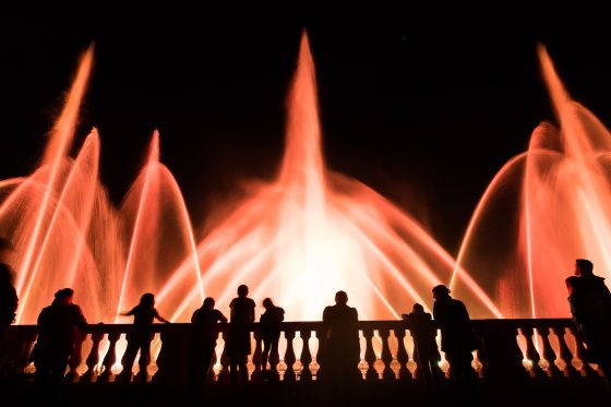 Main Fountain Garden show with orange lights against the fountain with silhouettes of guests