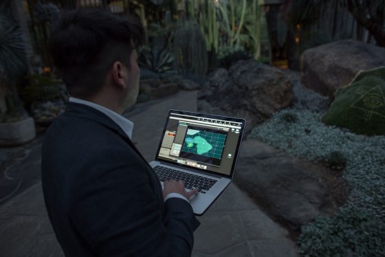 man holding a laptop creating the lights for the displays in the Silver Garden