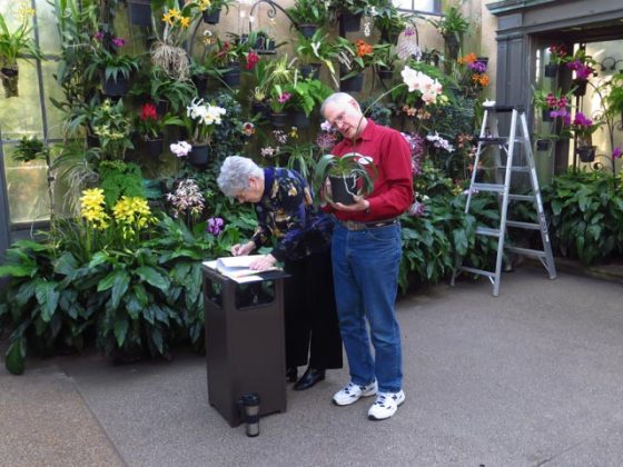  Two people in the Orchid House recording blooms
