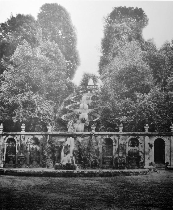 black and white photo of an arched wall fountain in a garden Italy taken around 1906