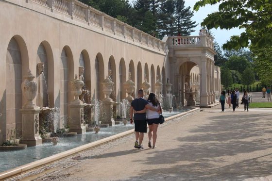 a couple walking down the Main Fountain Garden at Longwood Gardens