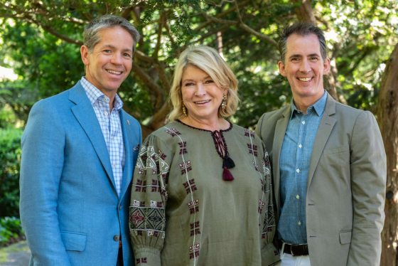 A group of three people smiling