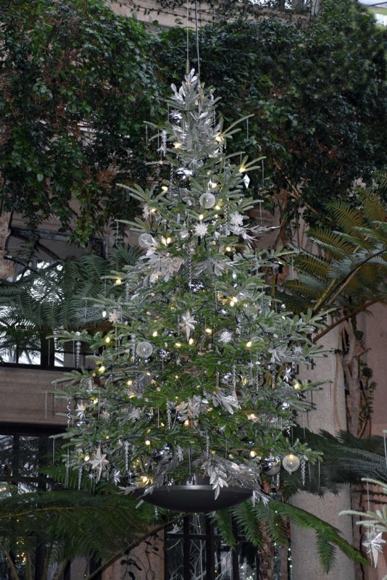 A decorated Christmas tree suspended from the ceiling