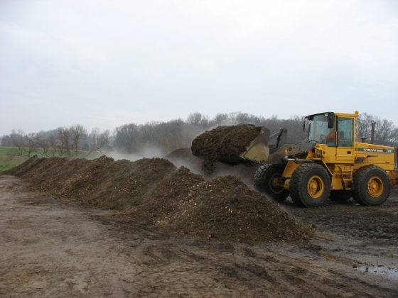 dine sustainability image showing yellow digger with piles of compost
