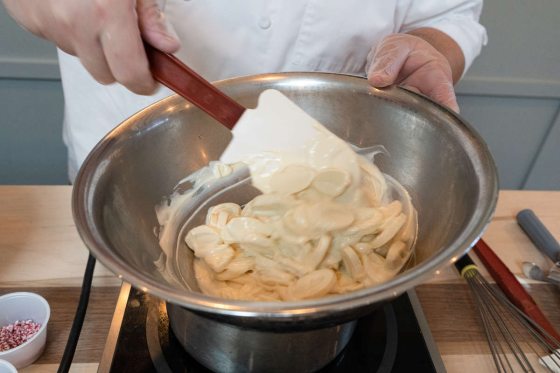 someone mixing batter in a large bowl