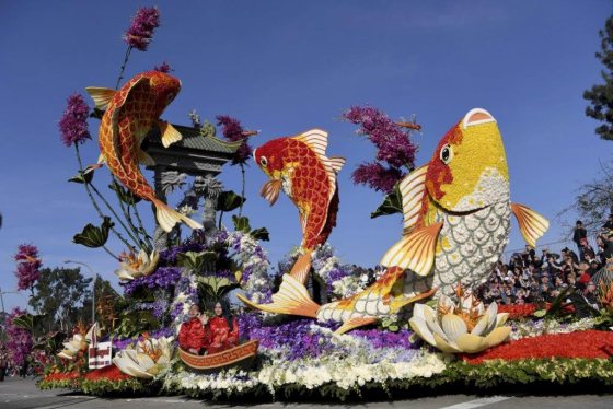a floral float with sculptures of three fish made out of flowers