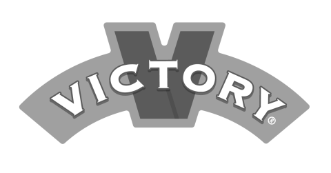 Block letters in white against a light blue arch centered by the "T" in "Victory" and a large red "V" in the background.